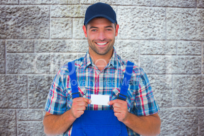 Composite image of portrait of happy handyman holding visiting c