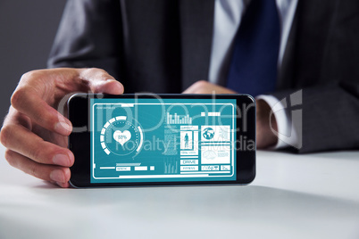 Composite image of businessman using smartphone Composite image of businessman using smartphone