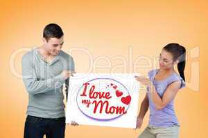 Composite image of young couple presenting banner together