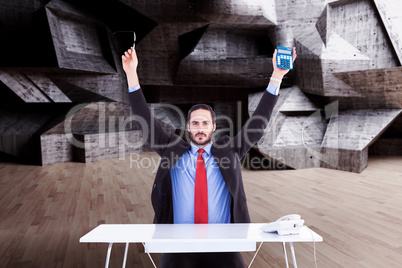 Composite image of businessman holding up reading glasses and ca