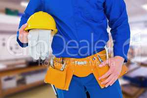 Composite image of handyman holding helmet