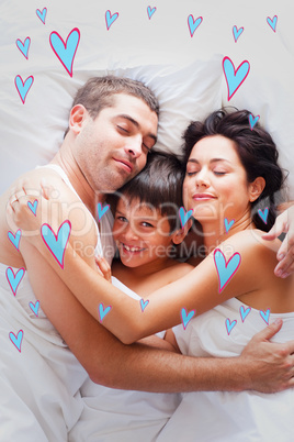 Composite image of happy family lying in bed