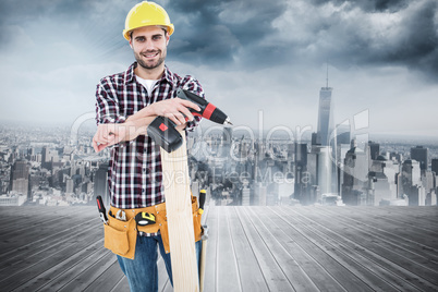 Composite image of confident male carpenter with drill machine a