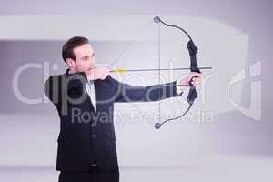 Composite image of businessman shooting a bow and arrow