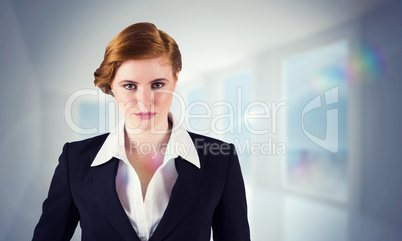 Composite image of stylish redhead businesswoman in suit