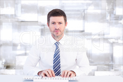 Composite image of businessman working at his desk Composite image of businessman working at his desk