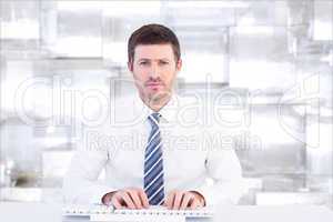 Composite image of businessman working at his desk