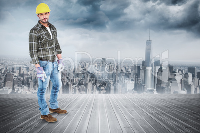 Composite image of full length portrait of confident handyman