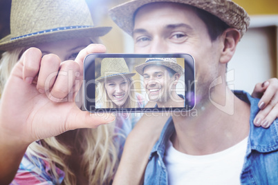 Composite image of hand holding smartphone showing