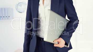 Composite image of businesswoman holding laptop