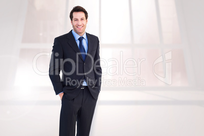Composite image of smiling young businessman with hands in pocke