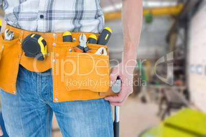 Composite image of technician with tool belt around waist