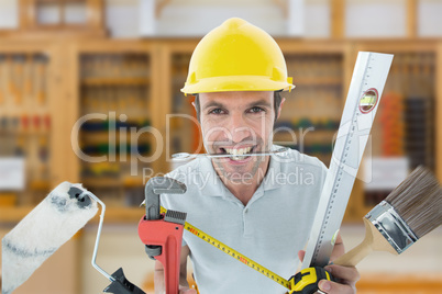 Composite image of happy worker with various equipment