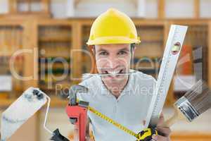 Composite image of happy worker with various equipment