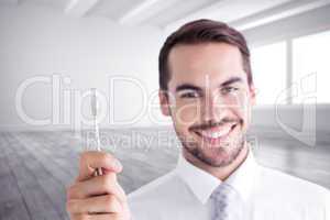 Composite image of happy businessman holding white cable