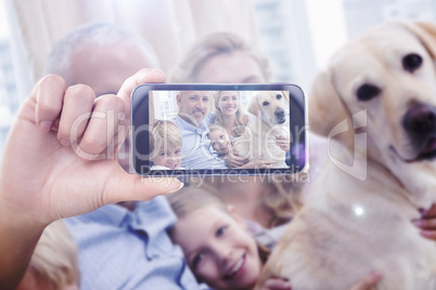 Composite image of hand holding smartphone showing