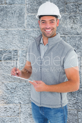 Composite image of portrait of smiling supervisor writing on cli