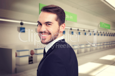 Composite image of elegant businessman in suit smiling at camera