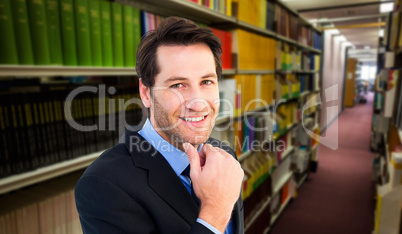 Composite image of businessman touching his chin while smiling a