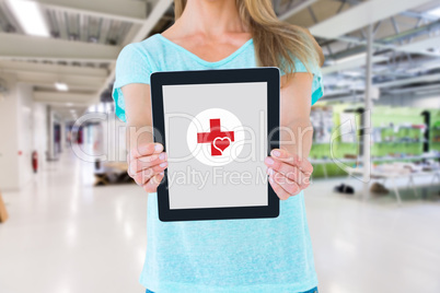 Composite image of mid section of woman showing a tablet pc Composite image of mid section of woman showing a tablet pc