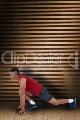Composite image of fit man stretching his legs