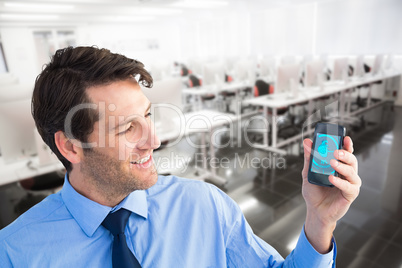 Composite image of smiling businessman showing smartphone to camera