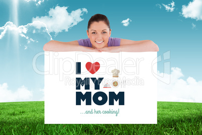 Composite image of good looking woman posing behind a billboard