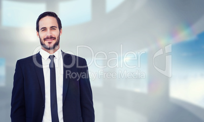 Composite image of smiling businessman in suit standing with han