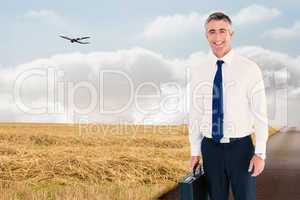 Composite image of smiling businessman wearing a headphone