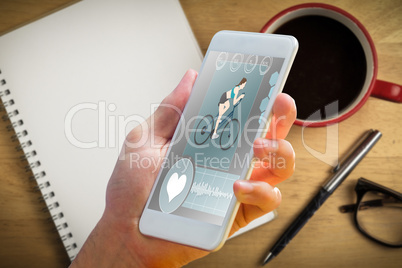 Composite image of hand holding smartphone