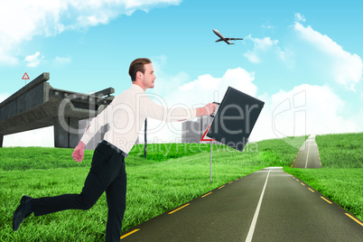 Composite image of businessman walking with his briefcase