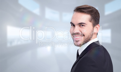 Composite image of elegant businessman in suit smiling at camera