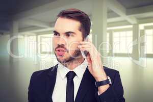 Composite image of smart businessman speaking on the phone