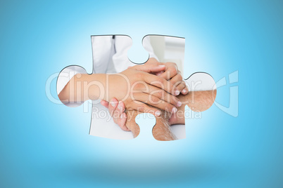 Composite image of close-up mid section of a doctor holding pati