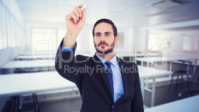 Composite image of businessman holding a chalk and writing somet