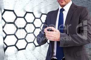 Composite image of focused businessman texting on his mobile pho