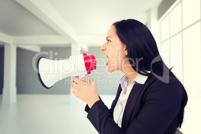 Composite image of pretty businesswoman shouting with megaphone