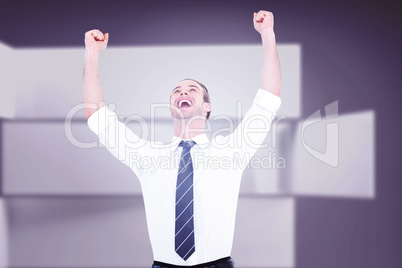 Composite image of handsome businessman cheering with arms up