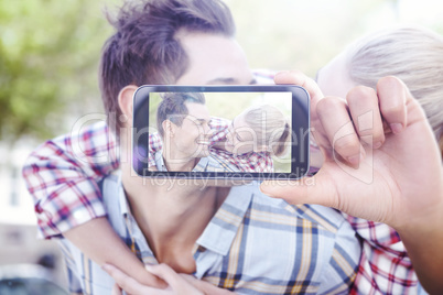 Composite image of hand holding smartphone showing