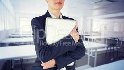 Composite image of businesswoman holding laptop