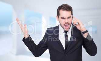 Composite image of angry businessman gesturing on the phone