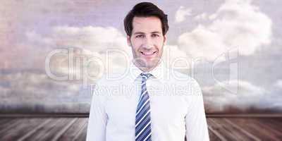 Composite image of smiling businessman standing with hands in po