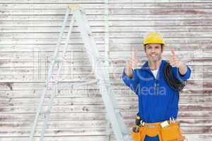 Composite image of happy electrician gesturing thumbs up by ladd