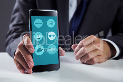Composite image of businessman using smartphone