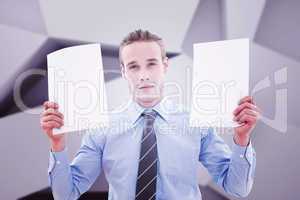 Composite image of businessman holding pages