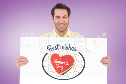 Composite image of attractive man smiling and holding poster