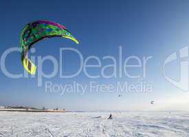 Kiteboarder with kite on the snow