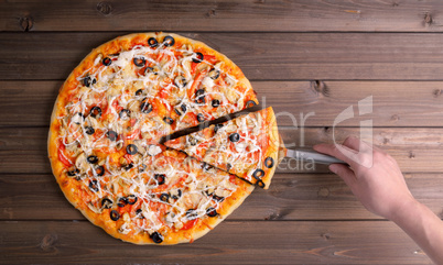 Pizza with cheese and pizza paddle