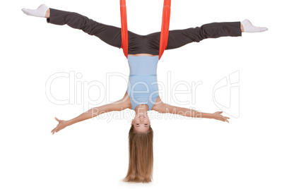 Young woman making antigravity yoga exercises in stretching twine