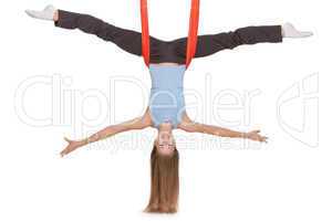 Young woman making antigravity yoga exercises in stretching twine